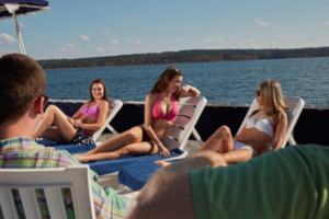 Three girls sunbathing on the deck of the boat